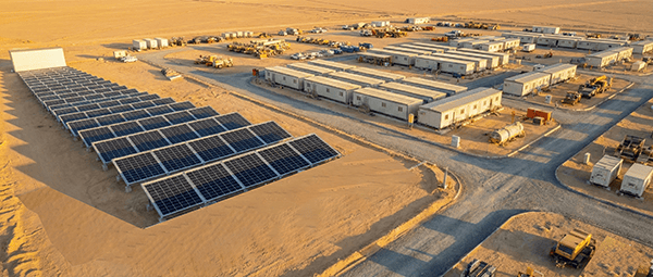 Large-scale off-grid solar microgrid system powering a remote mining camp and worker accommodation in the desert.